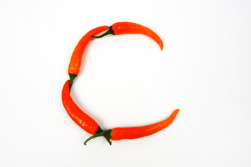 English alphabet. Letter C made of fresh chili pepper isolated on white background. Uppercase letter.