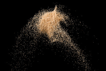 Sand splash explosion isolated on black background ,throwing freeze stop motion object design