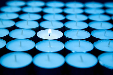 Creative, bright idea and innovation or inspiration concept. One candle burns, among others...