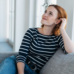Naklejka premium Attractive trendy young woman relaxing at home