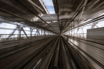 motion-blurred view from a moving train running in tunnel