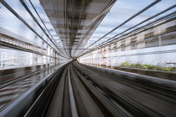 motion-blurred view from a moving train running in tunnel