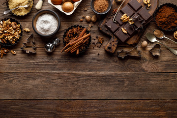 Christmas or new year culinary rustic wooden background with food ingredients for cooking festive dishes, xmas baking. Holiday cooking frame for Noel pastry on wooden table
