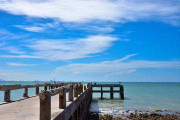Fototapeta na wymiar the bridge that stretches out into the sea is made of concrete against blue sky. Located on Pala Beach, Ban Chang, Rayong Thailand.