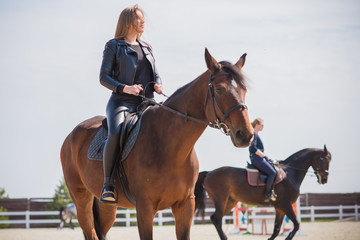Obraz premium Girl with a horse, countryside place, woman talking to her horse. Portrait of riding horse with woman at rancho 