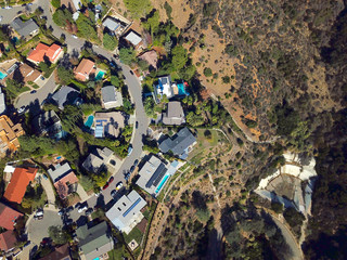 Aerial view of wealthy luxury villas in the valley of Hollywood. Top view of houses with swimming...