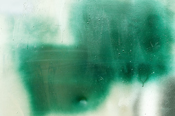 Green and white mix paint on metal surface, abstract texture