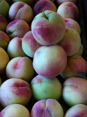  Group of peaches at the organic farmers market. Close up for background top view.                             
