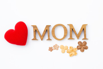 Mom wooden texture letter with paper flower and red heart isolate on white background, Mother's day card idea background