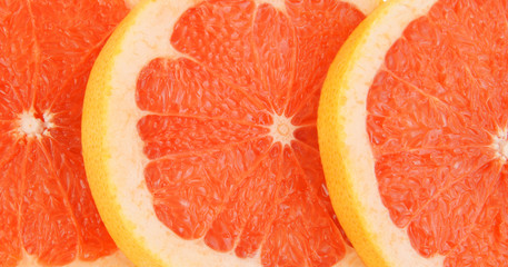 Red grapefruit slices close up
