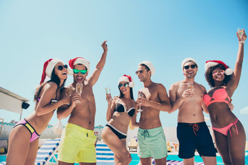 Photo of six multinational friends celebrating new year at tropics hanging out cool bikini feast