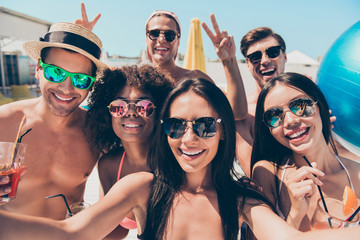 Close up photo of charming brunette students photographers making photos moments v-signs wearing...