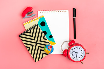 Stationary, back to school, summer time, creativity, education concept.School supplies - dividers, pencils, paper clips, note, stapler, notepad, globe on pink background, flat lay. Mock up Top view