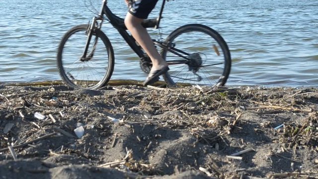 Athletes on bicycles passing on the beach in Armenia