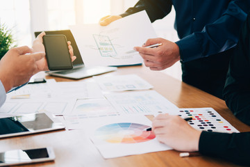 Creative UI designer teamwork meeting planning designing layout application mockup on smartphone screen