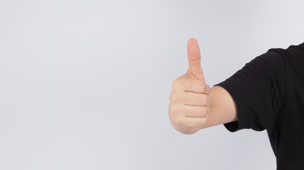 Male's right hand doing thumbs up sign on white background.