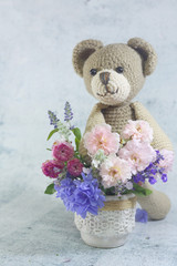 Teddy bear doll with flower bouquet