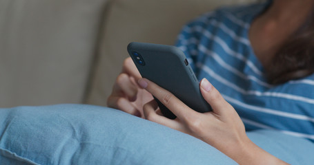 Woman use of mobile phone at home