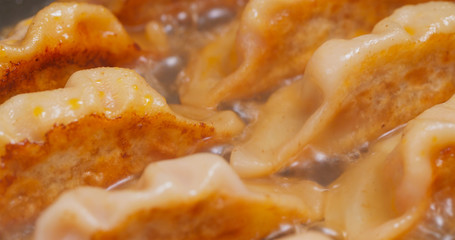 Fry meat dumpling in pan