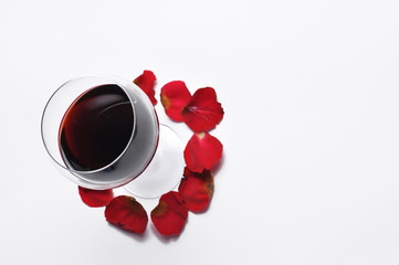 Wine glass and beautiful red rose isolated on white background