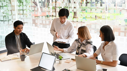 Startup business Team meeting with laptop and document paper with cropped shot.