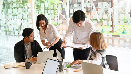Startup business Team meeting with laptop and document paper with cropped shot.