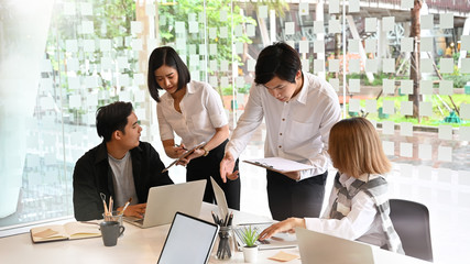 Startup business Team meeting with laptop and document paper with cropped shot.
