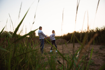 Pregnant woman with her husband walking in the open air