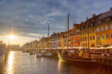 Copenhagen iconic view. Famous old Nyhavn port in the center of Copenhagen, Denmark during sunset