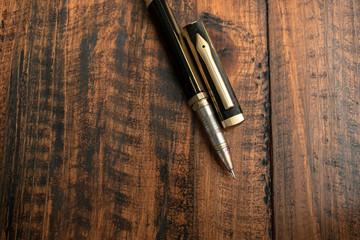 Old pen on wooden table