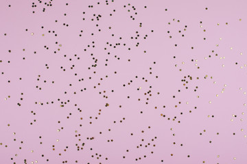 Golden sparkles stars on pink pastel trendy background. Festive background. Flat lay, top view