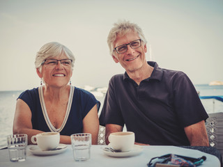 Retired couple enjoying coffee on a resort