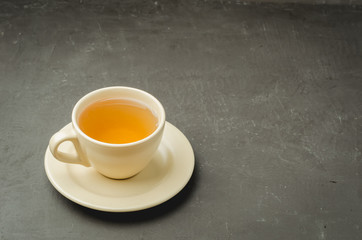 Obraz na płótnie Canvas Tea cup on dark stone table. Copyspace for your text