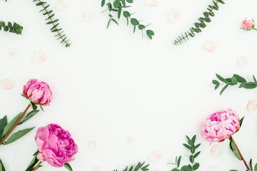 Floral frame with pink peonies, roses and eucalyptus on white background. Flat lay, top view
