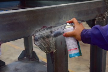 Penetrant Test , worker apply developer to the welding of structure for finding the defect.