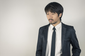 Portrait Businessman in Black Suit on Right Frame in Vintage Tone