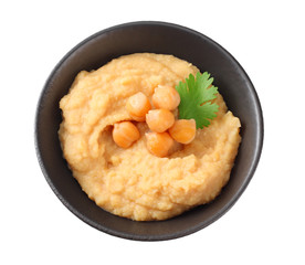 black bowl with chickpea hummus isolated on white background
