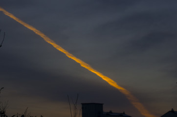 burning contrail in sunset
