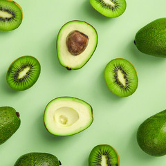 Avocado and kiwi frame on color background
