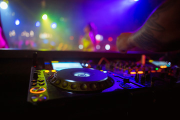 DJ playing music on light background