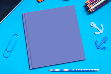 Blue empty book cover mock up, on the desk with stationary