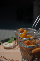 various snacks on the table, cheese plate, deep-fried cheese sticks, cheese balls, french fries. beer snack