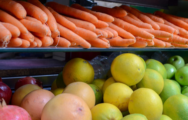 Fresh fruits and vegetables displayed in front of juices store at farmers market