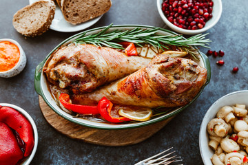 Festive dish for Thanksgiving, roasted turkey legs with vegetables on a table with snacks. Top view, flat lay.