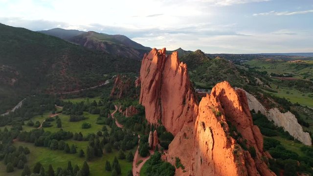 Aerial, drone shot, towards the red mountains, at the Garden of the Gods park, on a sunny evening, in Colorado springs, USA