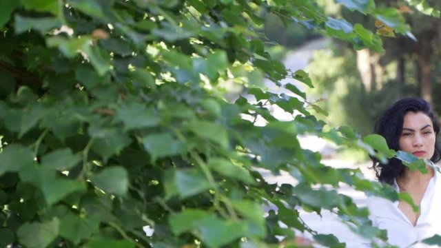 Beautiful tatar girl stands near the tree