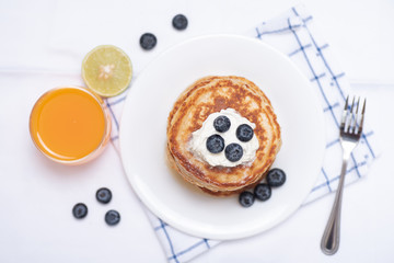 Oatmeal pancake with blueberry and juice, top view