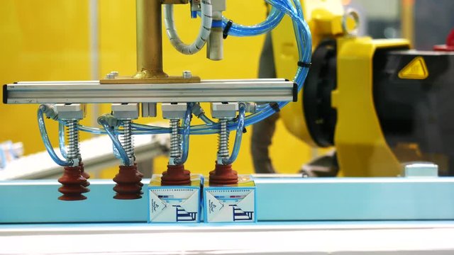 Robotic machine sorting the juice boxing at the robotics forum exhibition. Media. Robots and innovative technologies in Russia