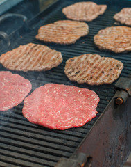 Street food. Fry meat patties (burgers) fresh beef on the grill