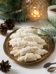 Traditional Moldavian shortcake cookies with jam stuffing and a cup of tea on the background of winter decor.